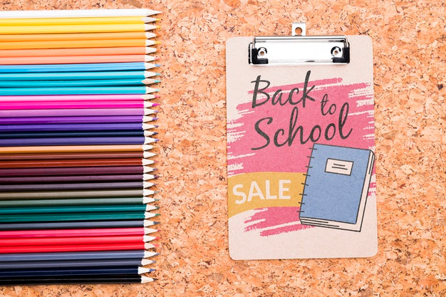 Free Clipboard Next To Colorful Pencils Mock-Up Psd