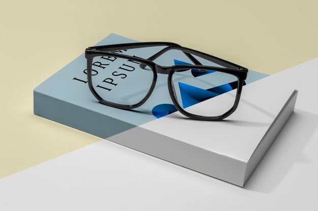 Free Close-Up Glasses On Book Mock-Up Psd