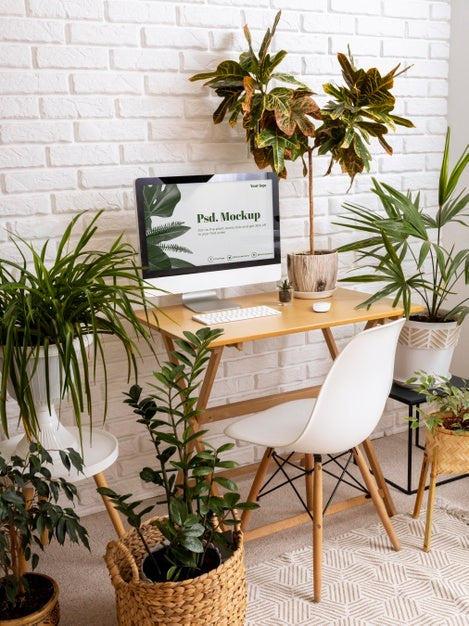 Free Close Up On Computer Mockup Surrounded By Plants Psd