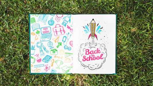 Free Colorful Book On Grass Mock-Up Psd