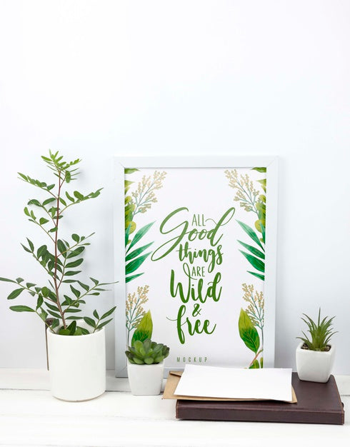 Free Composition Of Plants Next To Frame Mockup Psd