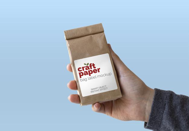 Free Craft Paper In Hand Mockup Psd