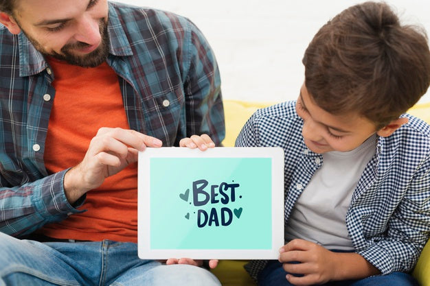 Free Dad And Son Holding Electronic Tablet Psd