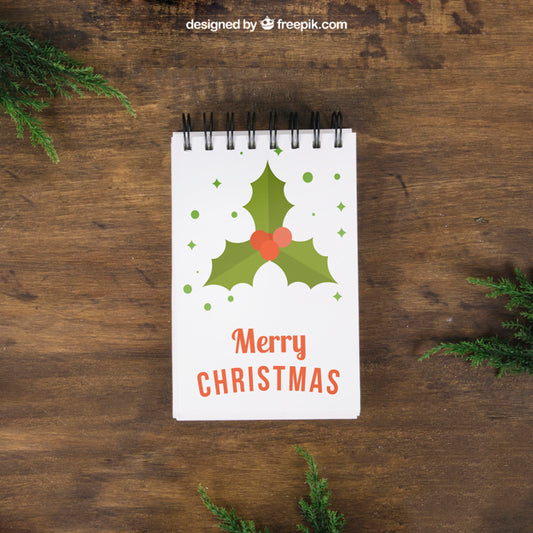 Free Decorative Christmas Mockup With Notepad And Mistletoe Psd