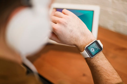 Free Defocused Man Working From Home While Looking At Smartwatch Psd