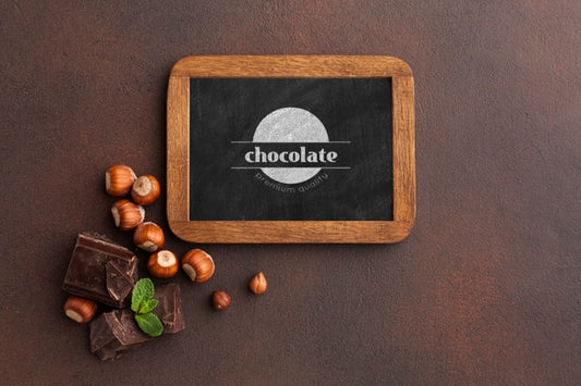 Free Delicious Chocolate With Blackboard Mock-Up On Brown Background Psd
