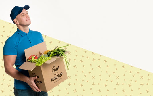 Free Delivery Man Holding A Box With Different Vegetables Mock-Up Psd