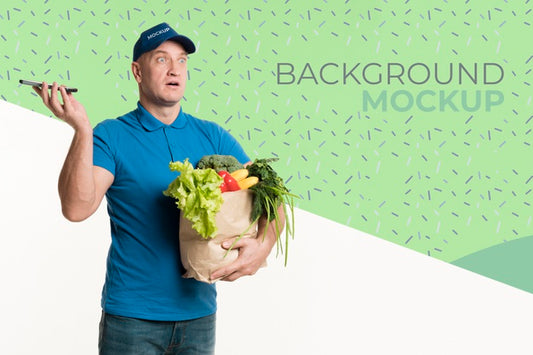 Free Delivery Man Holding A Box With Different Vegetables With Background Mock-Up Psd