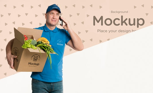 Free Delivery Man Holding A Box With Vegetables While Talking On The Phone Psd