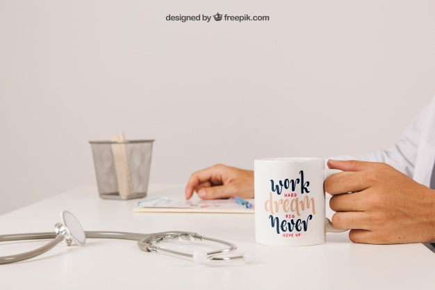 Free Doctor At His Desk With Coffee Mug And Clipboard Psd