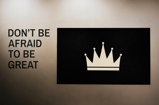 Free Don'T Be Afraid To Be Great Quoted On A Wall Next To A Crown Board Mockup Psd