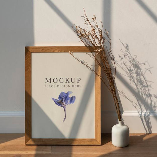 Free Dried White Statice Flower In A White Vase By A Wooden Frame Mockup On A Wooden Floor Psd
