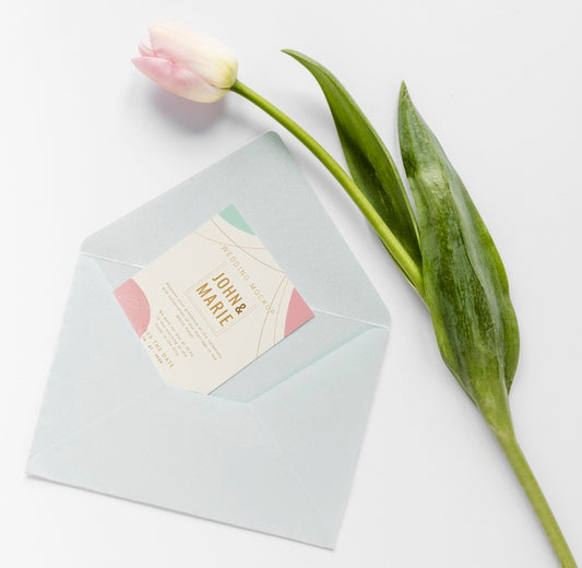 Free Fat Lay Of Wedding Card With Envelope And Tulip Psd