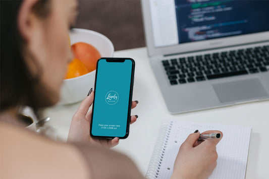 Free Woman Holding iPhone X Mockup and Taking Notes