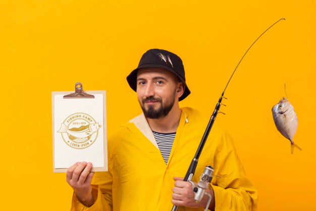 Free Fisherman In Raincoat With Trophy Fish In Rod Psd