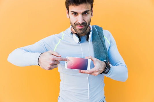 Free Fitness Mockup With Man Showing Smartphone Psd