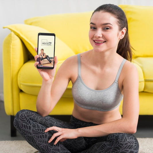 Free Fitness Woman Holding A Mobile Phone Mock-Up Psd