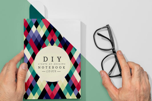 Free Flat Lay Hand Holding Book Mock-Up And Glasses Psd