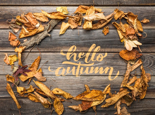 Free Flat Lay Of Autumn Leaves On Wooden Table Psd