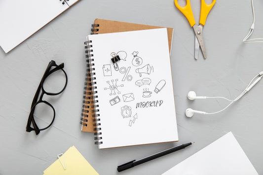 Free Flat Lay Of Desk Surface With Earphones And Notebooks Psd