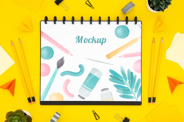 Free Flat Lay Of Desk Surface With Notebook And Pencils Psd