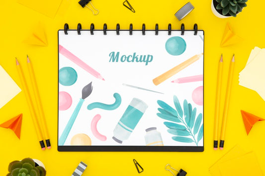 Free Flat Lay Of Desk Surface With Notebook And Pencils Psd