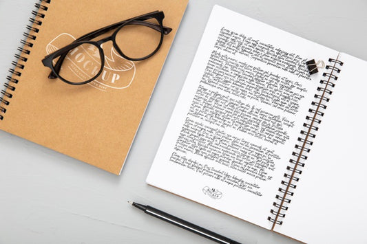Free Flat Lay Of Desk Surface With Notebooks And Glasses Psd
