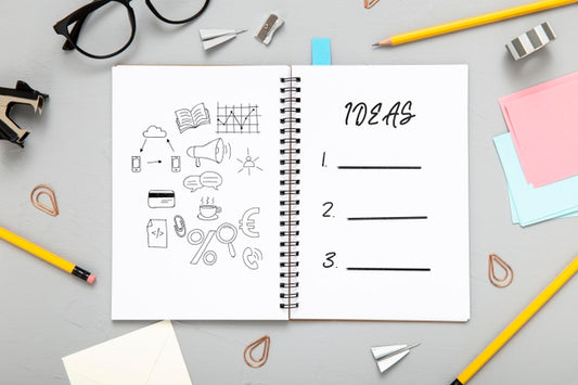 Free Flat Lay Of Desk Surface With Notepad With Pencils Psd