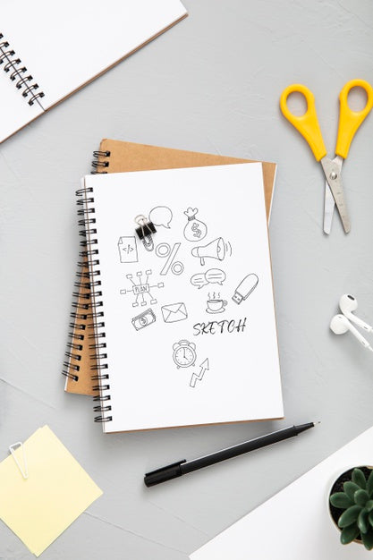 Free Flat Lay Of Desk Surface With Scissors And Notepad Psd