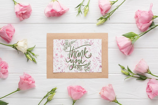 Free Flat Lay Of Frame And Flowers On Wooden Background Psd