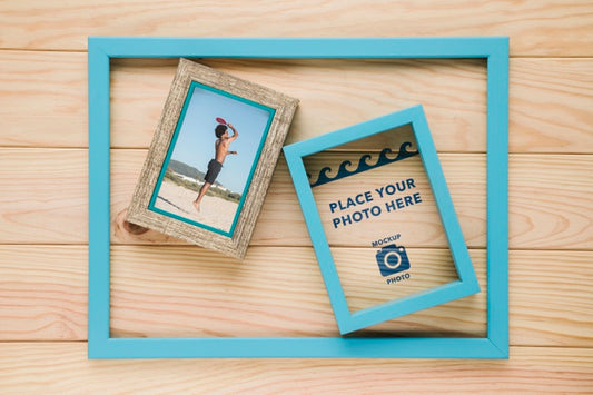 Free Flat Lay Of Frames In Frame On Wooden Background Psd