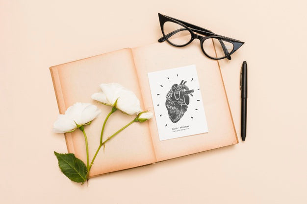 Free Flat Lay Of Open Book With Roses And Glasses Psd