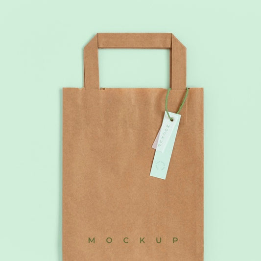 Free Flat Lay Of Paper Shopping Bag Mock-Up With Paper Tag Psd
