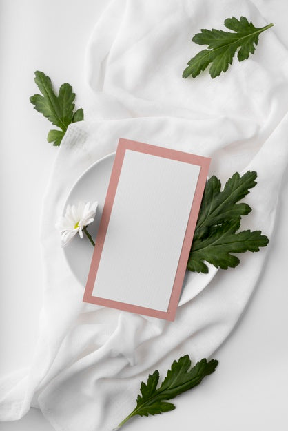 Free Flat Lay Of Table Arrangement With Spring Menu Mock-Up On Plate With Leaves And Flower Psd