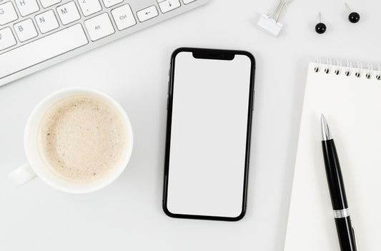 Free Flat Lay Smartphone Mock-Up With Empty Cup On Desk Psd
