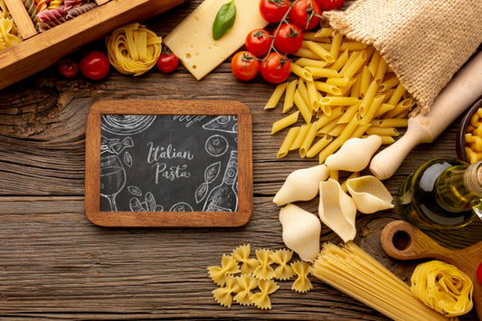 Free Flat Lay Uncooked Pasta Assortment And Tomatoes With Blackboard Mock-Up Psd
