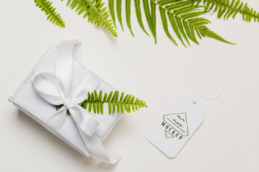 Free Flat Lay White Gift With Mock-Up Tag Psd