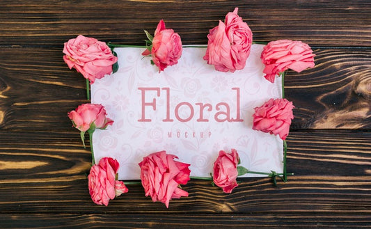 Free Floral Frame Pink Roses Mockup On Wooden Table Psd