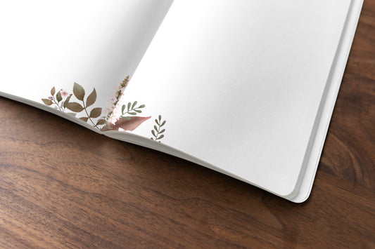 Free Floral Notebook Mockup On A Wooden Table Psd