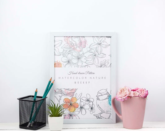 Free Flowers In A Cup Next To Frame Mockup Psd