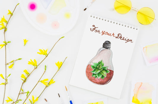 Free Flowers Next To Notebook With Artistic Draw Psd