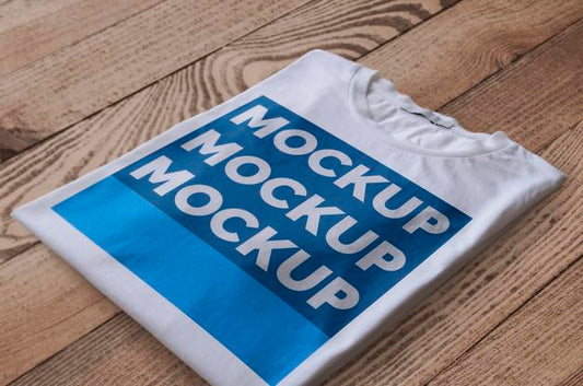 Free Folded White T-Shirt Over Wood Surface Mockup Psd