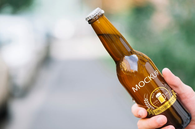 Free Front View Beer Bottle Held By Person Psd
