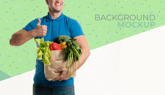 Free Front View Delivery Man Holding A Box With Different Vegetables Mock-Up Psd