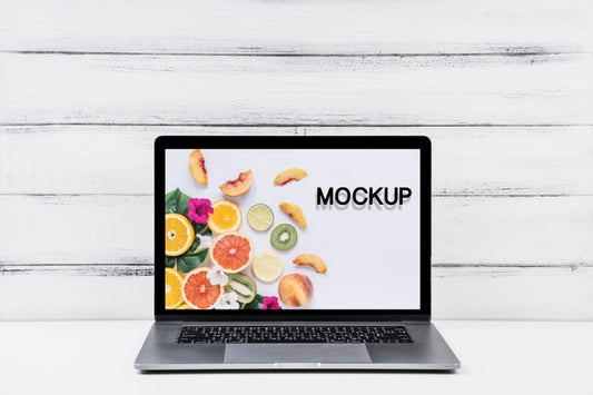 Free Front View Mock-Up Laptop With Wooden Background Psd