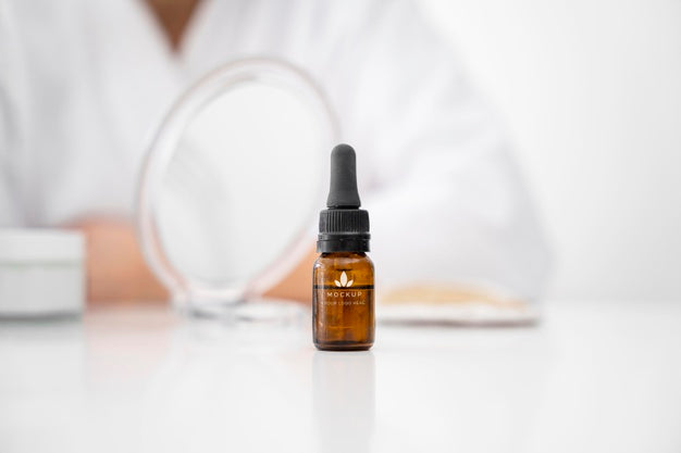 Free Front View Of Cosmetic Bottle With Pipette On The Table With Defocused Woman Psd