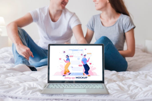 Free Front View Of Couple And Laptop On Bed Mock-Up Psd