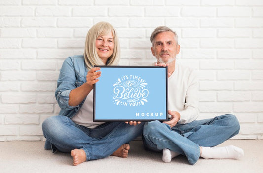 Free Front View Of Couple Holding A Frame Mock-Up Psd