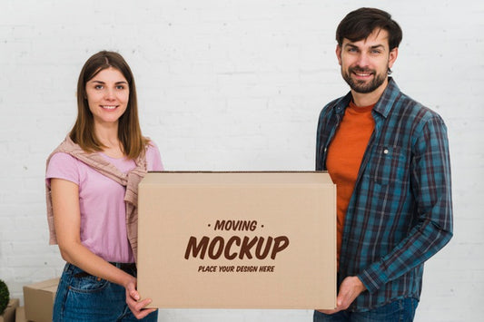 Free Front View Of Couple Holding Moving Box Mock-Up Psd