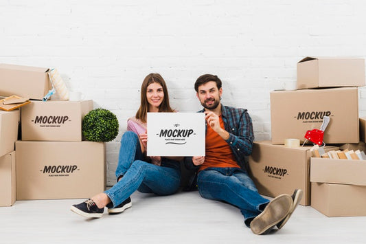 Free Front View Of Couple Posing With Moving Boxes Psd